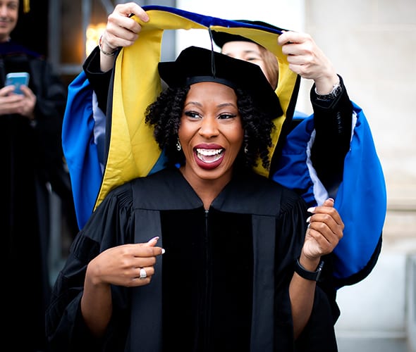 Graduate receiving hood during ceremony