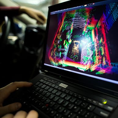 A video-game-esque rainbow outline of a room on a laptop screen
