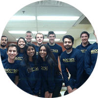 Students wearing biophysics shirts gather and smile for a picture