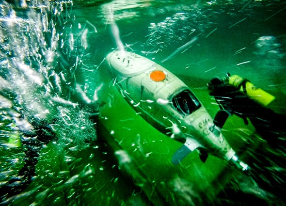 The two students in scuba gear on the Michigan Human-Powered Submarine team practices navigating the submarine underwater